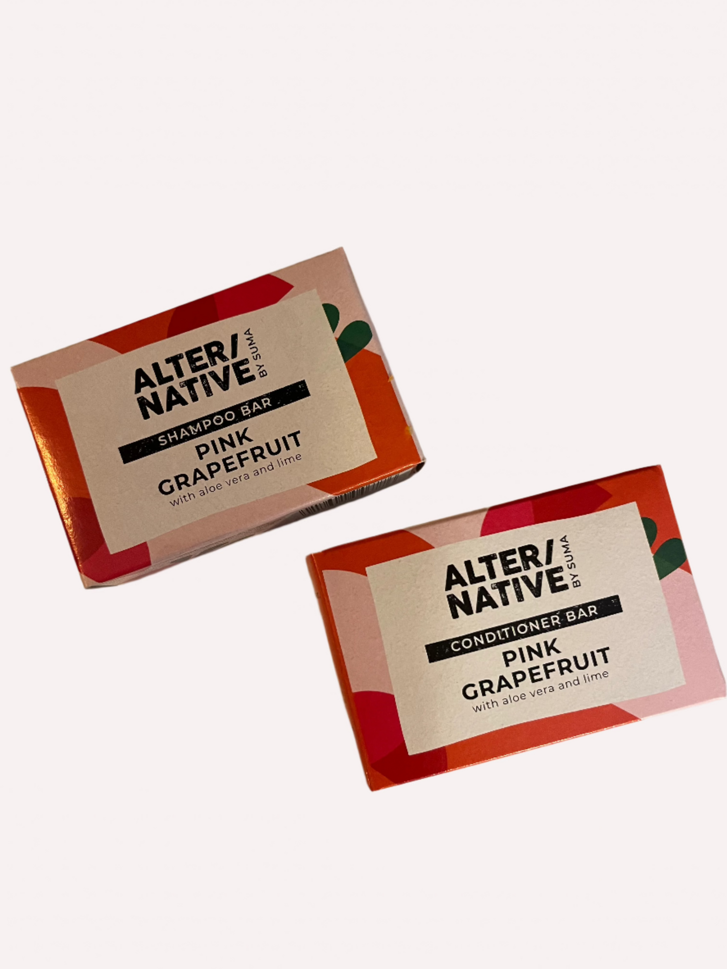 Two plastic free solid shampoo and conditioner bars in their brightly coloured rectangular boxes.