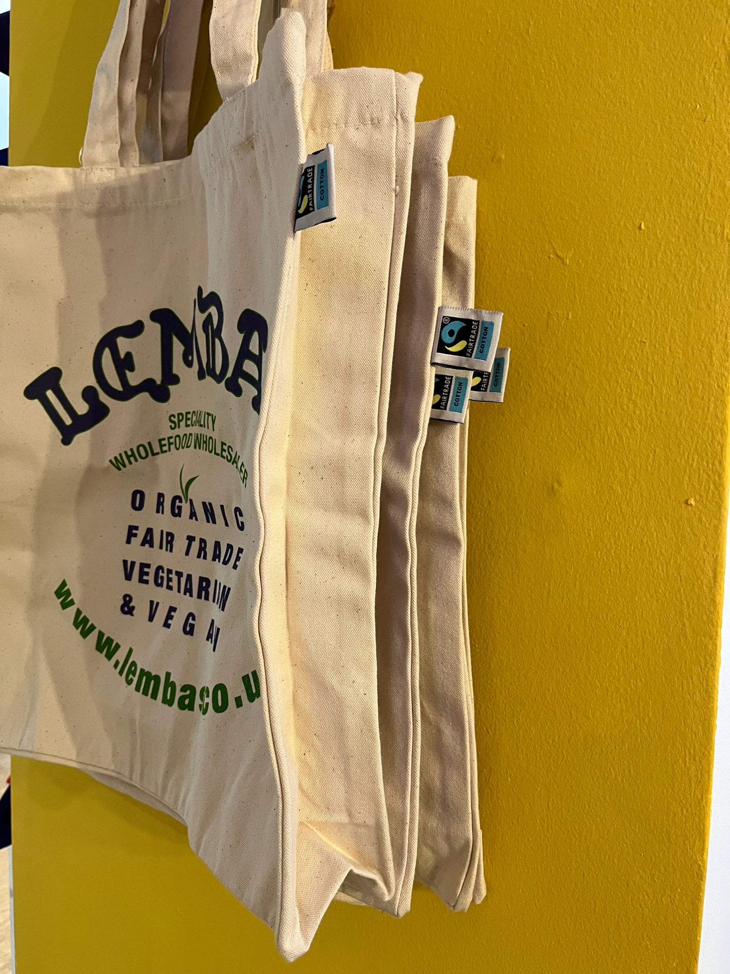 A view showing the gusset at the side of the large, strong cotton tote bag, and a Fairtrade label.