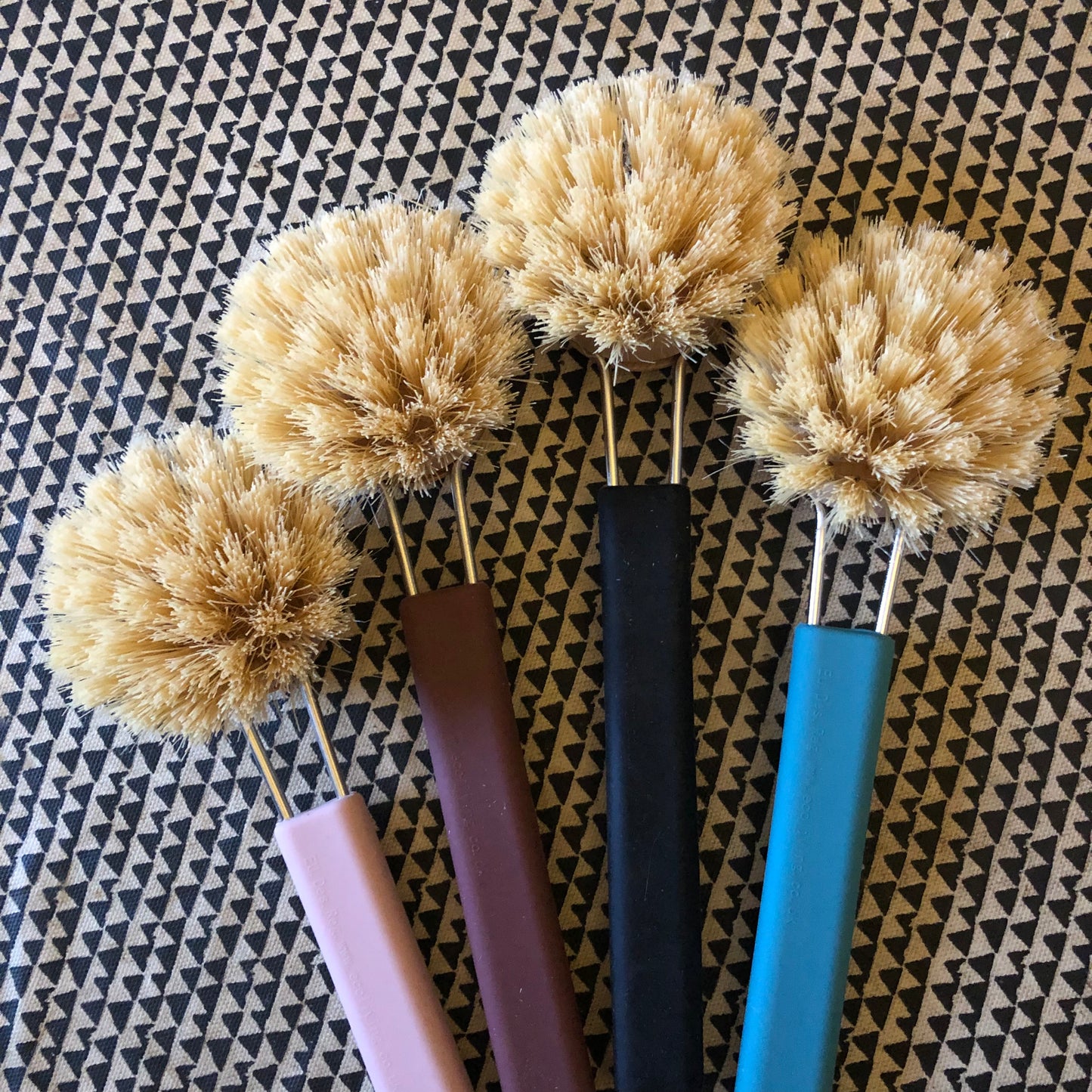 Modern design washing up brushes with soft silicone handles and replaceable wooden heads with natural bristles.
